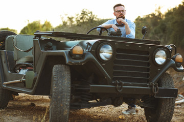 Fototapeta premium Young stylish man with glasses and bow tie near the old-fashione