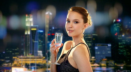 young asian woman drinking champagne at party