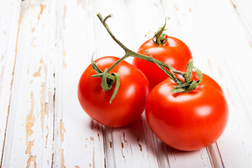 Ripe tomatoes on old table from boards.