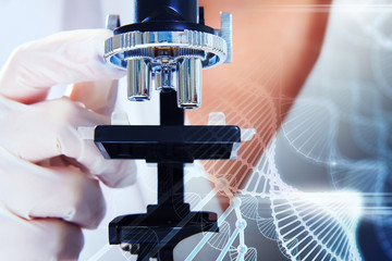 Scientist looking through a microscope closeup