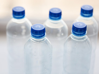 close up of bottles with drinking water on table