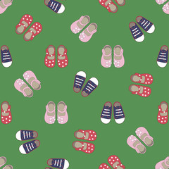 Kids seamless pattern with colored shoes on green background