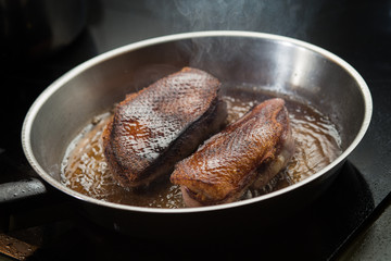 Duck fillet on grille pan. Poultry meat prepared on a grill. Fresh, delicious, spicy dish on a kitchen with copy space closeup and copy space.
