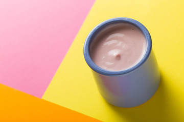 Yogurts assortment  in ceramic bowls on colorful background. Natural and fruit healthy, diet, gourmet dessert for granola breakfast. Sweet yoghurts closeup.
