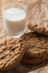 Cookies pile with chocolate chip on light textile background. Delicious morning snacks for breakfast, brunch and lunch. Appetizing, healthy, sweet, scrummy, and fast food.