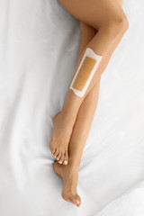 Body Care. Long Woman's Legs With Wax. Depilation Concept