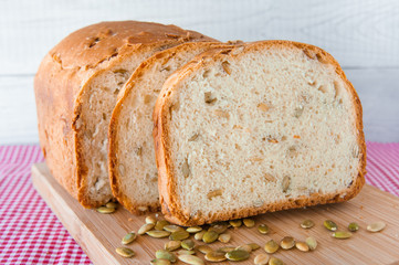 Loaf of white bread with green pumpkin seeds