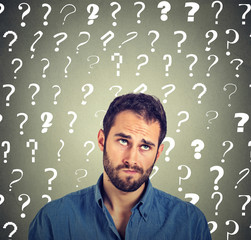 funny confused skeptical man thinking looking up has many questions