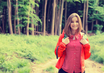 Fototapeta na wymiar Young hiker in forest smiling enjoying nature. Leisure activity concept.