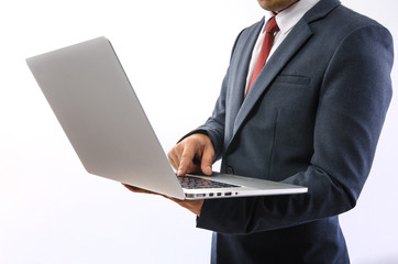 Double exposure of a businessman and a city using a laptop