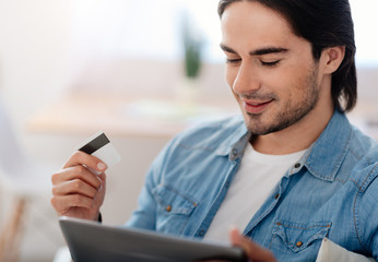 Positive man doing payment online