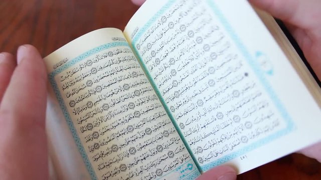 The small Holy Quran in hands