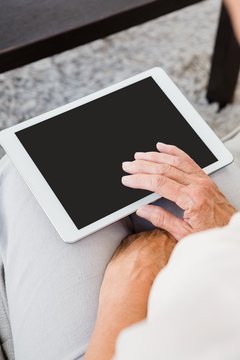 Cropped image of woman using digital tablet