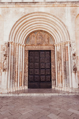 Fototapeta na wymiar Facade and front entrance of the church of St. Anastasia in Zadar, Croatia