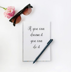 Flower and sunglasses with notepad, motivational text on it
