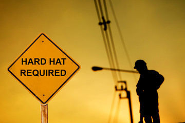 Message Hard hat required with worker on background
