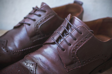 Image of male brown shoes over the wooden table