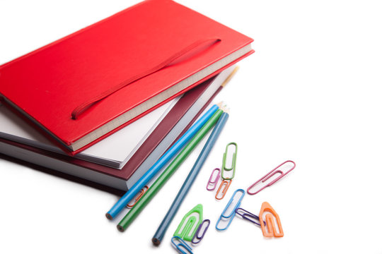 notebooks and paperclips isolated