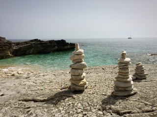 Fototapeta na wymiar Three piles of rocks on a beach