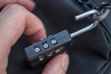 Hand opens suitcase combination lock 