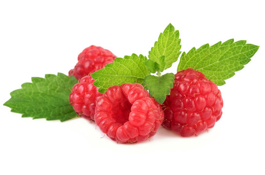 organic raspberries with mint leaves on white closeup