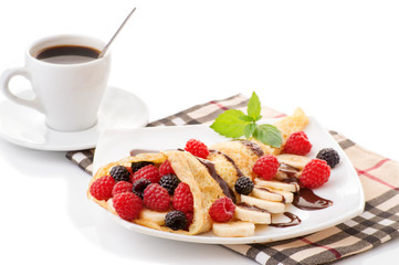Cup of coffee and pancakes with berries