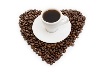 white cup of coffee on  beans as a heart