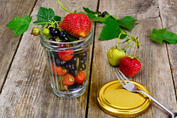 Strawberry, Black Currant and Tea on Wooden Rustic Background