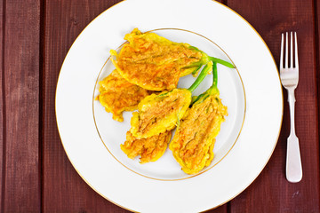 Flowers of Zucchini, Fried in Batter on a Wooden Background