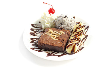 chocolate brownie with banana  ice cream and cherry on top