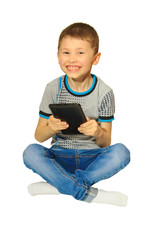 Boy with tablet, sitting cross-legged