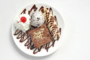 chocolate brownie with banana  ice cream and cherry