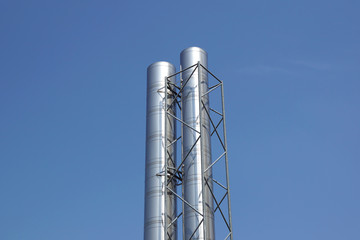 smokestacks with blue sky background