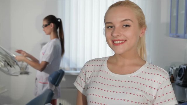 Woman demonstrates satisfaction of dentist checkup