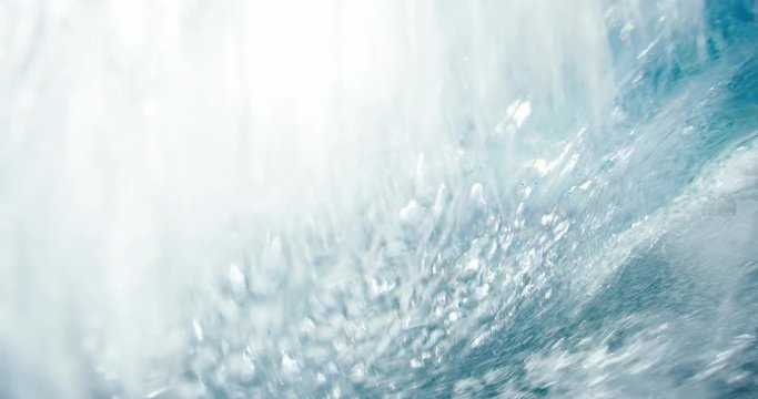 Beautiful blue ocean wave breaking in slow motion