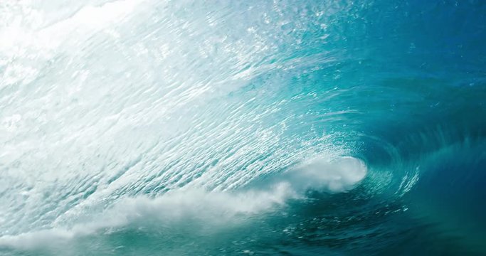 Beautiful blue ocean wave breaking in slow motion