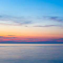 sunset on the beach with a wooden breakwater, long exposure