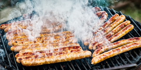 Meat sausages roasted on the grill