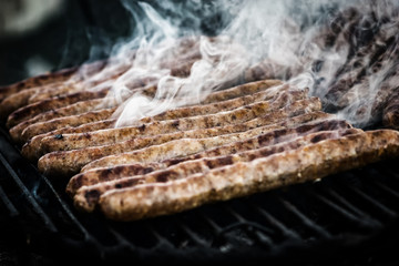 Meat sausages roasted on the grill. Grungy, dirty post processin