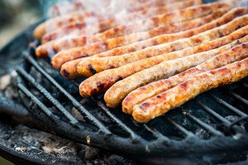 Meat sausages roasted on the grill