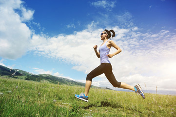 healthy young woman trail runner running on beautiful trail