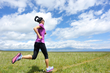 healthy young woman trail runner running on beautiful trail