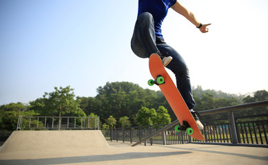 young woman skateboarder skateboarding at skatepark