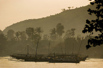 Bali Fishing Boat. These strange looking Balinese fishing boats work at night with powerful lights to attract the fish. These are anchored in the village of Pemuteran in northwest Bali. © LoweStock