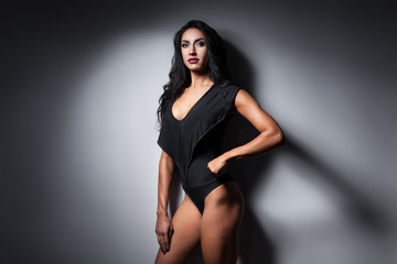 studio shot of perfect body of bodybuilder female;