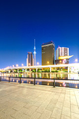 modern buildings near tokyo tower from empty floor at twilight