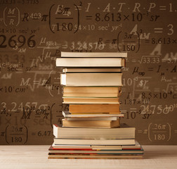 Books on vintage background with math formulas