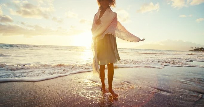 Beautiful young woman walking on the beach in slow motion, soft warm vintage sunset color tone
