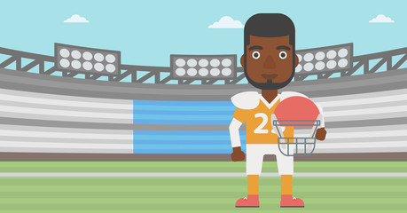 Rugby player with ball and helmet in hands.