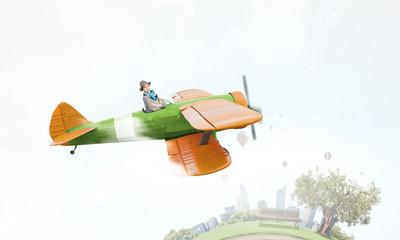 Naklejka na ściany i meble Girl flying old plane . Mixed media